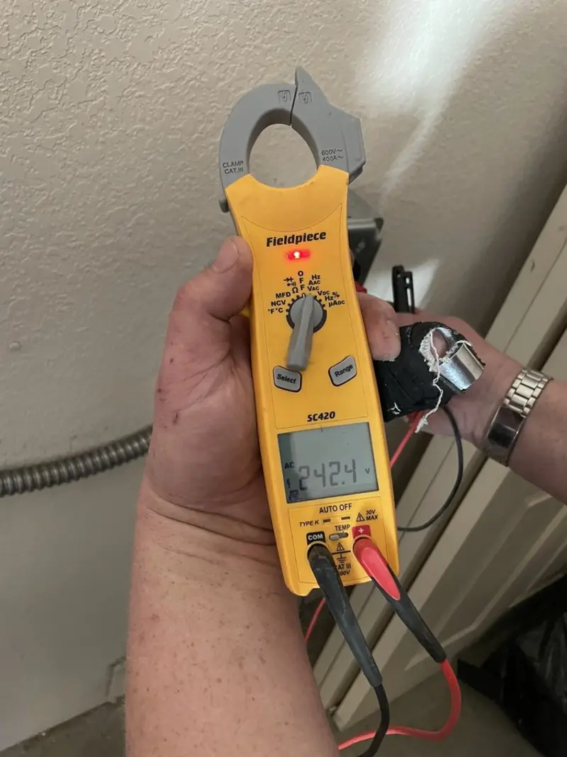 Voltage testing with clamp meter during Ceiling Fan Installation in Flowood